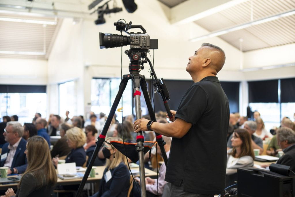 Person taking video footage at a UCSC conference